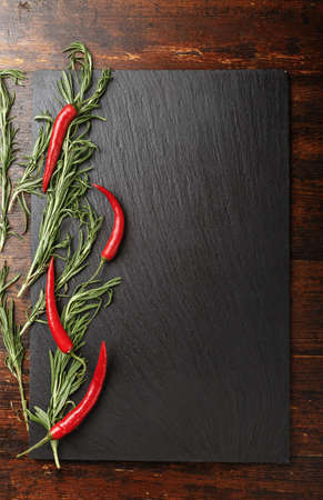 hot pepper and rosemary on a wooden background. Close-up, top viewの写真素材