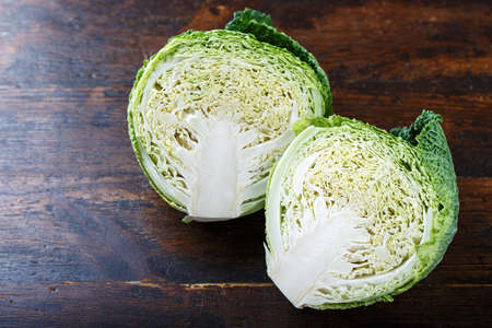 Cut savoy cabbage on a wooden background, close-upの写真素材