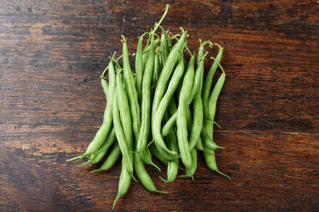 Fresh washed organic green beans on a cutting board