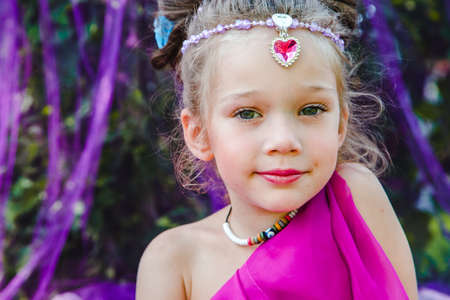 small European girl in oriental dress, crimson color, in a tent outdoors, harmony, staged shooting
