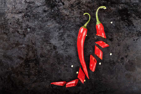 hot pepper slices and seeds, beautifully stacked composition on a black background, space for textの写真素材