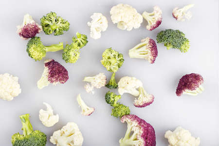 inflorescence of colorful cauliflower - white and purple and broccoli on white backgroundの写真素材