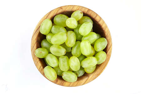 green berries of grapes in a plate isolated on a white backgroundの写真素材