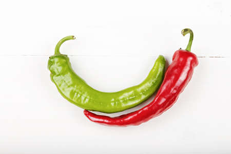 red and green chili peppers on white background, horizontal photo. Space for text