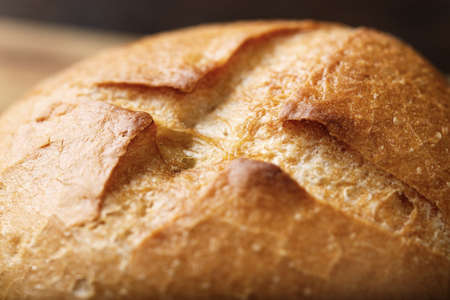 fresh crispy wheat rolls of white flour on a wooden background, close-upの写真素材