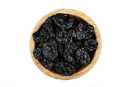 Prunes in a plate isolated on a white backgroundの写真素材