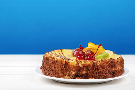 delicious birthday cake, cream cake with cherries, oranges and chocolate, space for textの写真素材