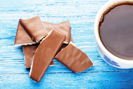 Chopped chocolate and tea on the wooden deskの写真素材