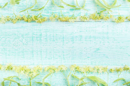 linden blossoms on a wooden background, room for text. relaxing and healthy Linden teaの写真素材