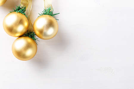 Christmas garland with toys gold balls on white background, with space for textの写真素材