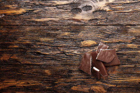 Chopped chocolate on the wooden desk. top viewの写真素材