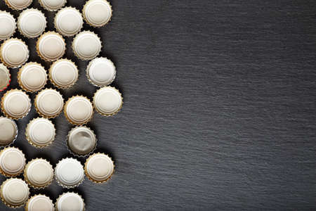 many inverted covers of beer are laid out in rows, with space for textの写真素材