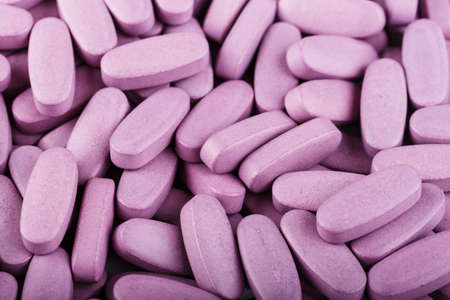 many large pink tablets are scattered as a background