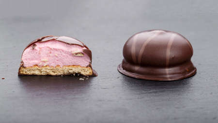 Round chocolate candy on a black slate board