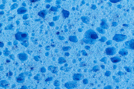 Texture of a blue sponge close-up, well visible pore washcloths
