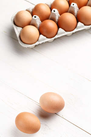 Raw, brown, chicken eggs on wooden white boards.の写真素材