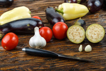 Raw diced eggplant in a bowl, tomato and garlic, detail of a cut raw vegetables, vegetarian food, healthy lifeの写真素材