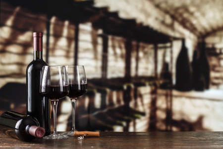 Wine cellar with wine bottle and glasses.with space for textの写真素材