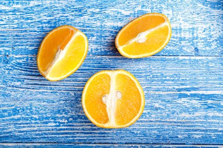 Orange slices on a wooden table, juicy organic orange, vitamin Cの写真素材