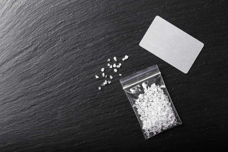 drugs in the form of crystals on a black background, methamphetamine in a plastic bag
の写真素材