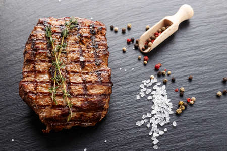 Cooked steak marble grilled meat with spices. Photo for menu, space for textの写真素材