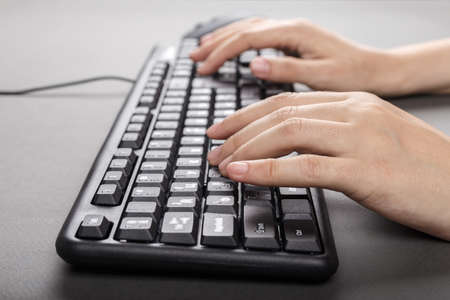 two female hands on the keyboard, work in the office, office equipment, space for text