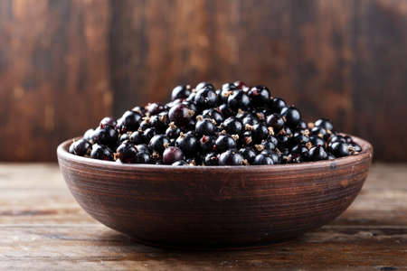 natural antioxidant fresh organic currant on a wooden background, space for text
の写真素材