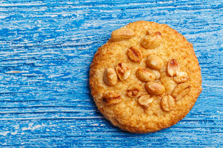 homemade cookies with peanuts on a blue shabby wooden background, top view, space for textの写真素材