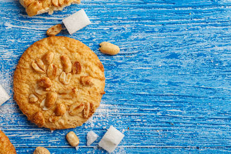 appetizing homemade cookies with peanuts on a blue shabby wooden background, biscuits broken. top view, space for text
の写真素材