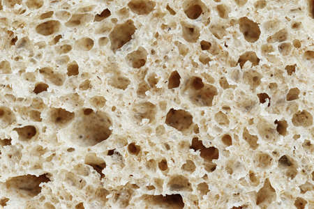 Texture of white bread, photo of a sliced piece of bread, close-up, space for text