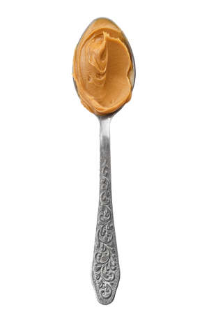 spoon with natural organic peanut butter, on white background, isolated