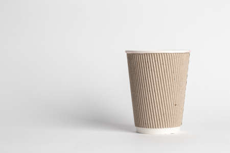 coffee to go in a disposable cup on a white background, place for text