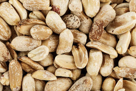 a lot of peanut peeled as background, close-up, space for text