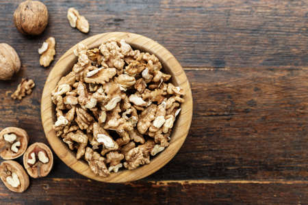 walnuts on a wooden background, in a plate. a useful nutritious protein product. place for text
の写真素材