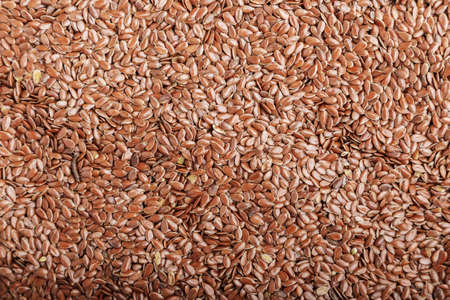 a lot of flax seeds are scattered as a background, place for text
