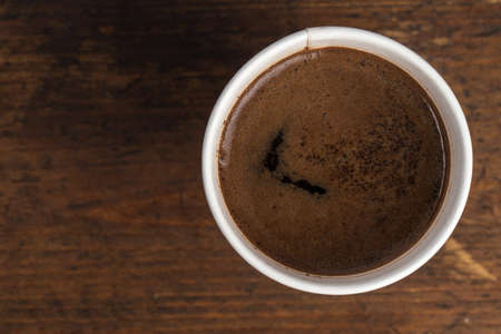 coffee to go in a disposable cup on a white background, place for text. top viewの写真素材