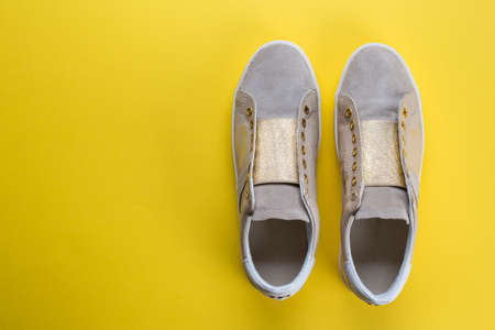 women's new sneakers on a yellow background, space for text, top view
の写真素材