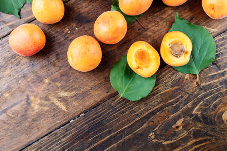 scattered apricots on a wooden background, space for textの写真素材