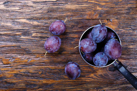 Garden plums in bowl. Organic food. Top view with copy space for your textの写真素材