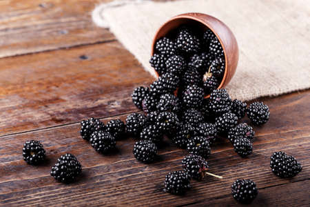 Blackberry on a wooden background. space for text. top view