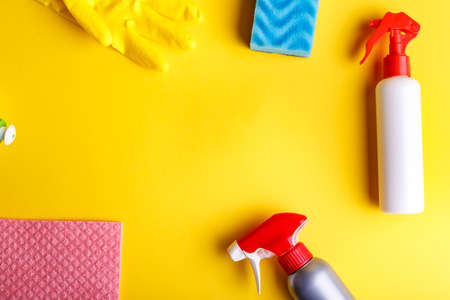 detergent set with a washcloth and gloves on a yellow background, space for textの写真素材