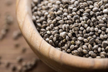 cannabis seeds in a plate, on a wooden background, space for textの写真素材