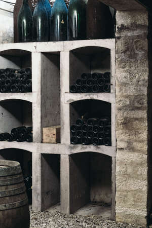 Many bottles of wine in the cellar are stacked in dense rows on the shelves of wine cabinets, winemakingの写真素材