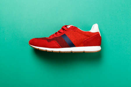 One red sneaker on a bright contrasting background. place for text