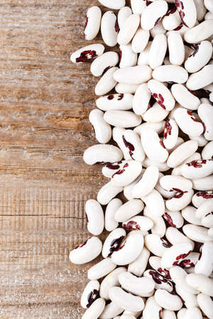 raw white beans on the table place for text as a backgroundの写真素材