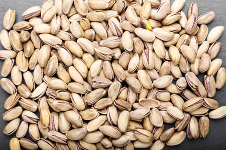 many pistachios are scattered. traditional beer snack. space for text