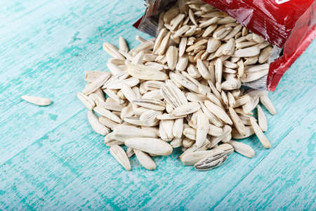 many white sunflower seeds scattered on the table place for textの写真素材