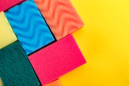 A lot of sponge for washing dishes on a yellow background.の写真素材