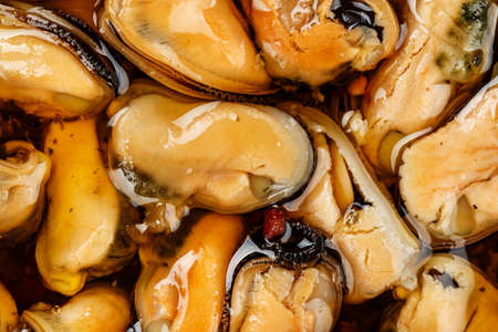 cooked mussels in oil, without shell, close-up. well-visible shellfish textureの写真素材