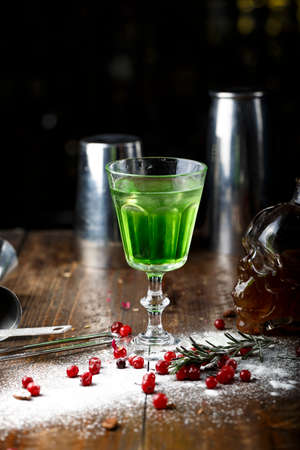 cocktail with absinthe for Halloween in a glass in the form of a skullの写真素材